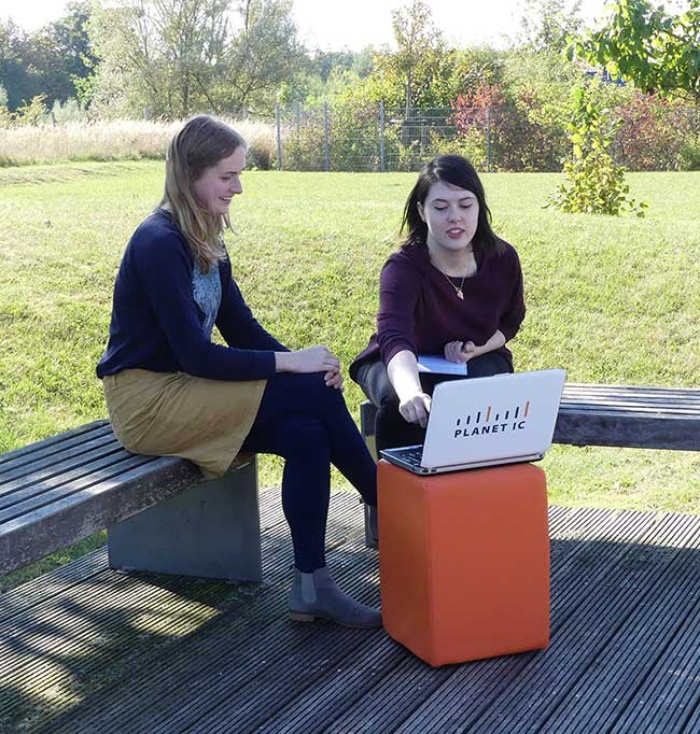 zwei junge Frauen bei einem PLANET IC Meeting im Freien